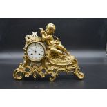 A late 19th century gilt brass and porcelain mantel clock, 36cm wide, (no pendulum).