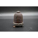 Treen: a good 19th century carved lignum vitae novelty bee skep string box, 12cm high.