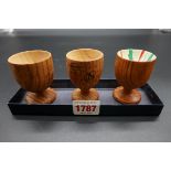 Of sporting interest: three pine eggcups, decorated and signed by Dickie Bird; Gaby Sabatini; and