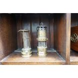 Two antique brass miner's lamps, one by 'E Thomas & Williams Ltd'; the other by 'Evans, Aberdare'.