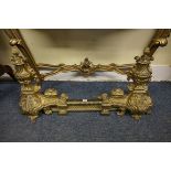 A late 19th century cast brass adjustable fire kerb, in the Louis XIV style, 45cm high.