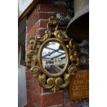 A Florentine style carved giltwood frame wall mirror, 51 x 36.5cm.
