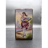 A small enamel vesta case, the hinged cover decorated with a lady holding a fan and a cigarette, 4.2