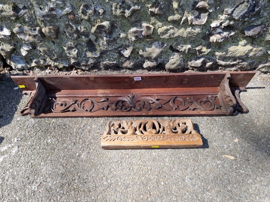 A carved oak wall shelf; together with a small wood carving.