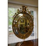 An impressive Victorian carved giltwood and gesso framed oval wall mirror, 116.5 x 82.5cm.