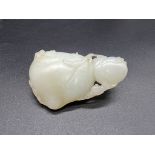 A Chinese carved celadon jade group of two peaches, Qing, 7cm wide.