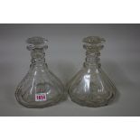 A pair of antique clear glass decanters and stoppers, 21cm high.