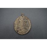 A medieval carved horn pilgrim's pendant or badge, decorated to both sides with religious figures,