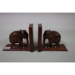 A pair of carved hardwood elephant bookends, 17.5cm.