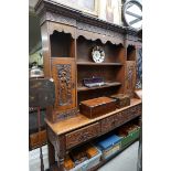 A Victorian carved oak dresser and rack, decorated with medieval figures and dragons, 187cm wide.