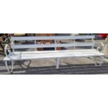 A white painted wrought iron garden bench, 240cm wide.