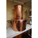 A large copper twin handled saucepan and cover, 45cm wide; and a matching asparagus pot and cover,