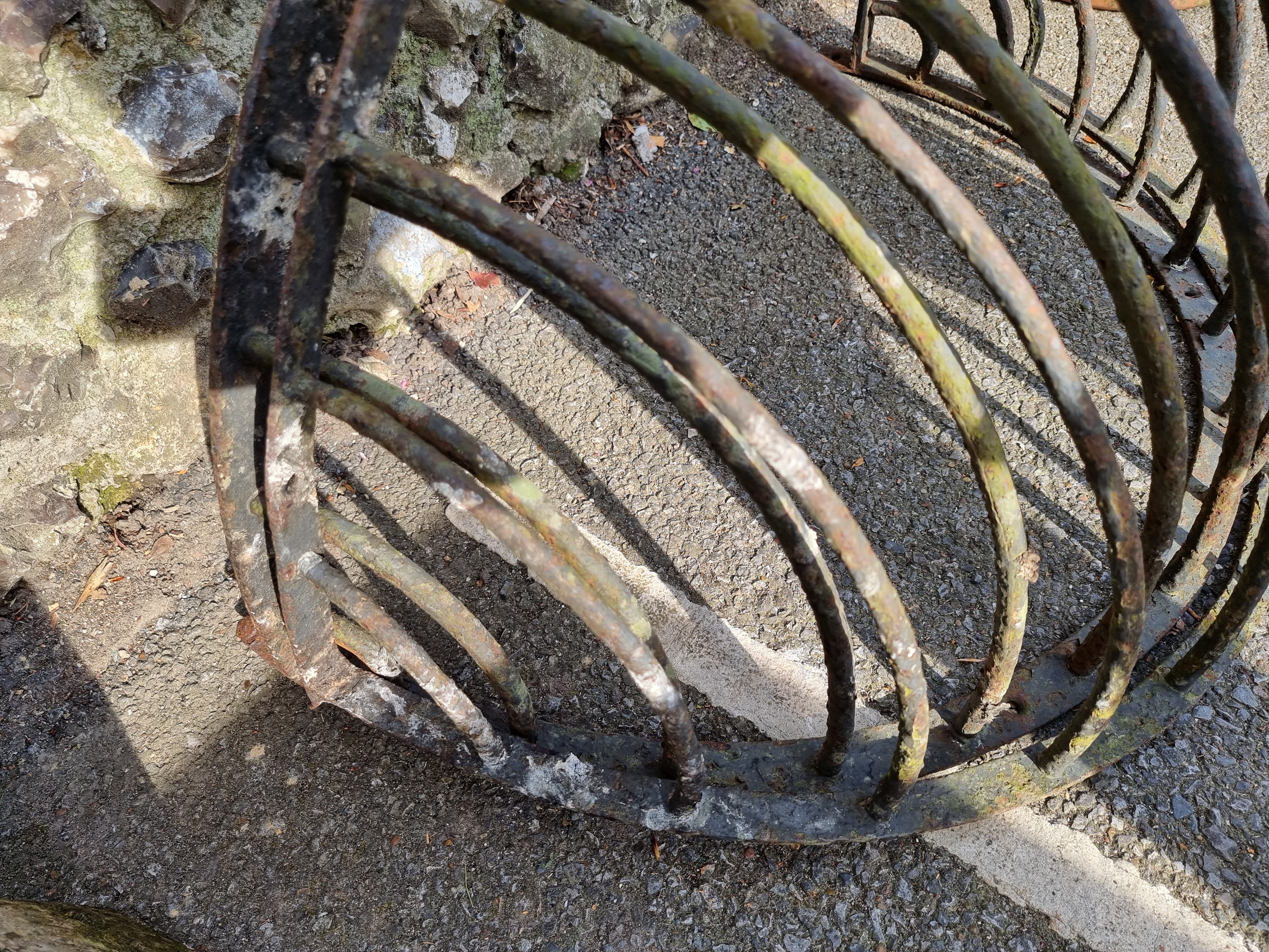 A pair of wrought iron wall mounted animal feeders, 80cm wide.