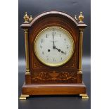 An Edwardian mahogany and inlaid mantel clock, the 5 1/2in circular enamel dial inscribed '