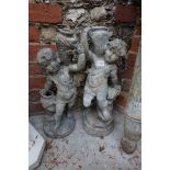 A pair of lead cherubs, 46cm high.