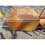 A vintage Ercol blonde elm drop leaf dining table, 136cm extended.