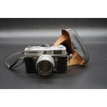 Cameras: a Canon Canonet QL17, with SE 45mm 1:1.7 lens, in original leather case.