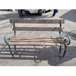 An old wrought iron garden bench, 143cm wide.