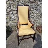 An Edwardian mahogany highback salon armchair.