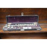 A rosewood flute, by Auguste Buffet, in fitted case.