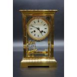 A French brass four glass mantel clock, with enamel dial and mercury pendulum, 27cm high.