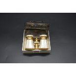 A pair of antique French gilt brass and mother of pearl opera glasses, in leather case.