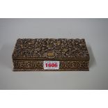 A brass stamp box, decorated with scrolling foliage, 15.5cm wide.