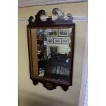 An antique mahogany and parcel gilt fret frame wall mirror, 71 x 41cm.
