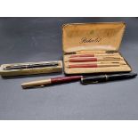 A small collection of vintage fountain pens, comprising a cased Parker 61 three pen set; two further
