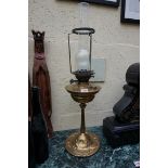 An Art Nouveau brass oil lamp, height excluding chimney 59.5cm.