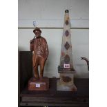 An onyx and marble obelisk, 47.5cm high; together with a carved walnut figure, 37cm high.