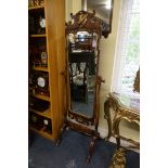 A 1930s walnut and parcel gilt cheval mirror, 180.5cm high.