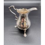 A George III silver cream jug, by I S & A N, London 1767, 10cm high, 97g.