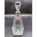 An Art Deco style cut glass decanter, having silver coloured collar, stamped VDM 950, 29cm high.