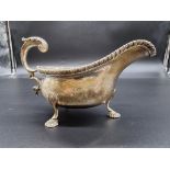 A silver sauce boat having gadrooned rim, makers mark rubbed, London 1911, 298g.