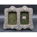 A Victorian silver double photograph frame, by James Deakin & Sons, Chester 1899, 23.5cm high.