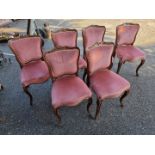 A set of six Victorian carved rosewood dining chairs.