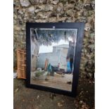 A modern black framed wall mirror.