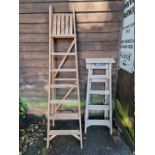 Two old wood folding step ladders.