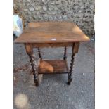 An oak occasional table, on barley twist legs, 70cm high x 57cm wide.