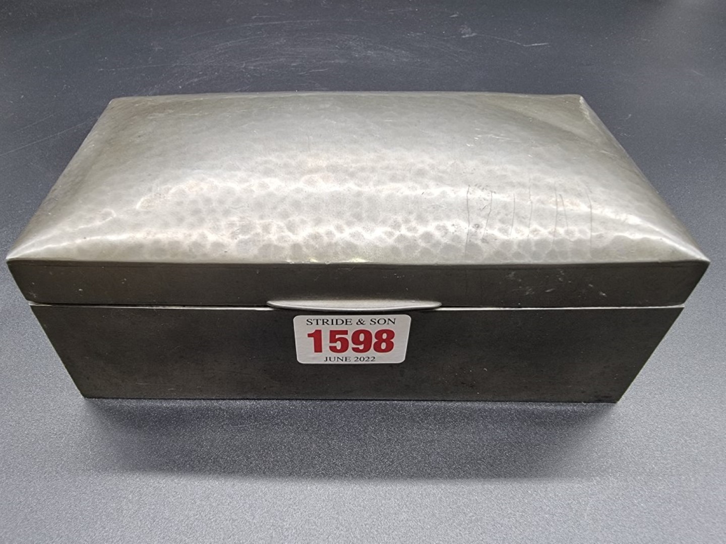 A Liberty 'Tudric' pewter cigarette box, No. 01021, 17.5cm wide.