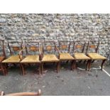 A set of six reproduction dining chairs, having brass inlay; to include a pair of carvers.
