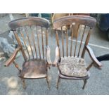 A pair of oak stickback elbow chairs.