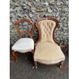 A Victorian walnut button back nursing chair; together with a walnut dining chair.