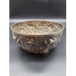 A Chinese white metal bowl, by Wang Hing, embossed with dragons, 23.5cm diameter.