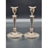 A pair of silver candlesticks, by Hawksworth, Eyre & Co Ltd, Sheffield 1911, 28.5cm, weighted.