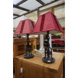 A pair of wrought iron table lamps, height including shades 57.5cm.