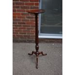 A good early 20th century carved mahogany tripod torchere, 107cm high.
