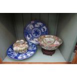 A Chinese famille rose bowl, 23cm diameter, on wood stand; together with three Japanese items.