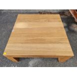 A contemporary pale oak coffee table, 85cm wide x 36cm high.